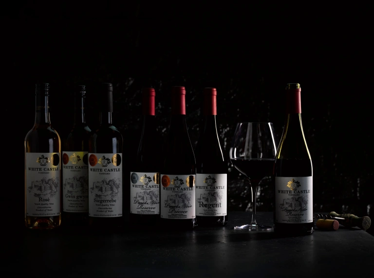 Seven bottles and white and red wine.