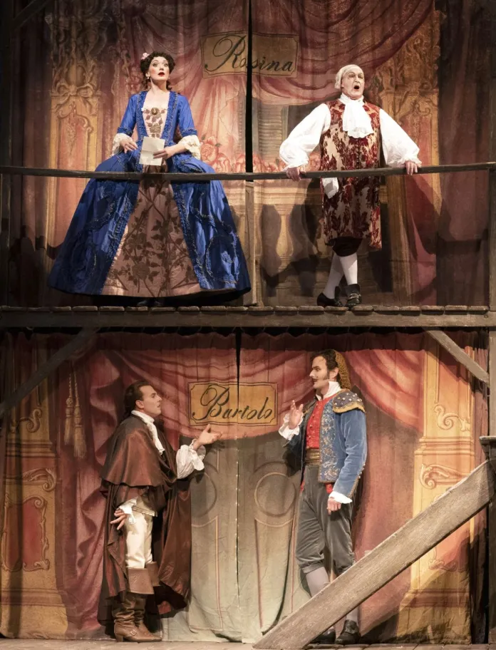 A group of opera singers performing on an elaborately decorated stage set