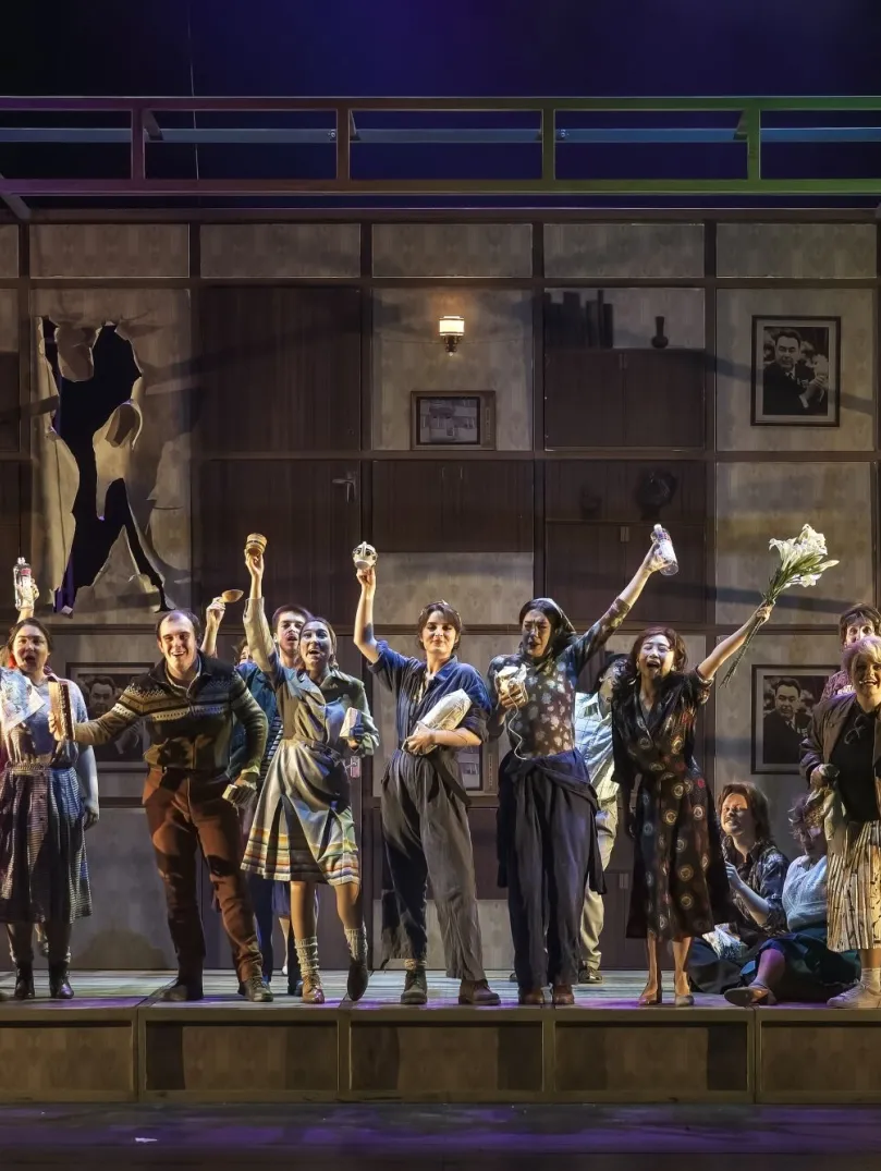 The cast of a large opera production performing on stage