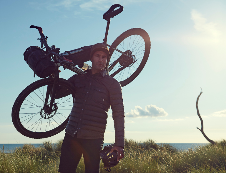 man carrying a mountain bike